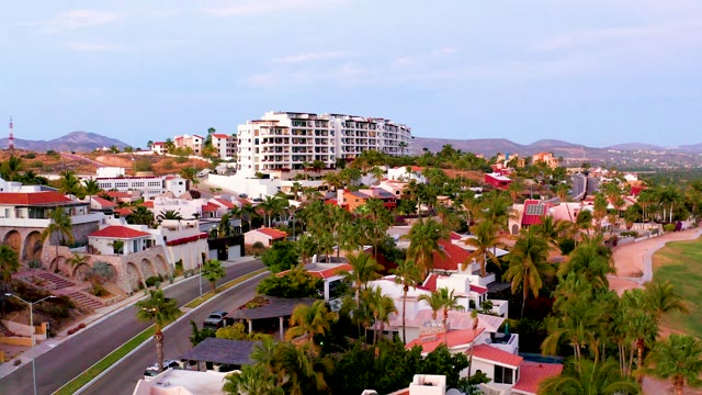 SAN JOSE DEL CABO MEXICO-2021: Car Driving Through Residential Neighborhood with Palm Trees