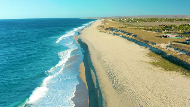 TODOS SANTOS BCS MEXICO-2021: Waves Gently Rolling Onto Sandy Beach