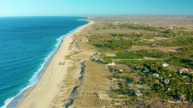 TODOS SANTOS BCS MEXICO-2021: Vehicle Moving Along Sandy Beach by Ocean