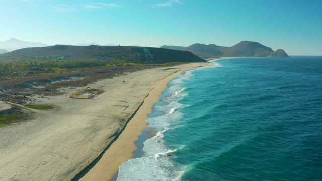 TODOS SANTOS BCS MEXICO-2021: Waves Rolling Onto Sandy Beach with Distant Hills