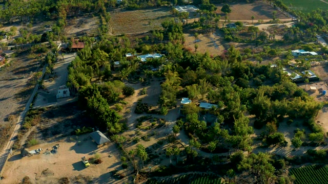 TODOS SANTOS BCS MEXICO-2021: Aerial Approach over Rural Settlement with Trees and Buildings