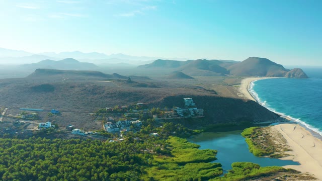 TODOS SANTOS BCS MEXICO-2021: People Moving Along Sandy Beach near Coastal Hills