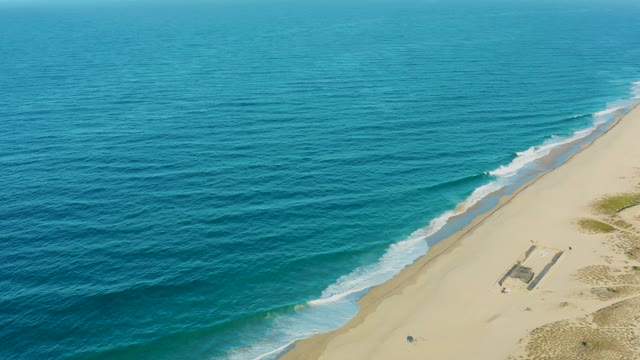TODOS SANTOS BCS MEXICO-2021: Person Moving near Small Beach Structure by the Ocean