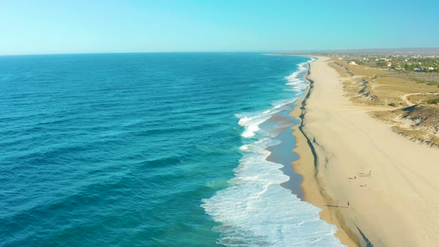 TODOS SANTOS BCS MEXICO-2021: People Walking Along Sandy Shore by Ocean