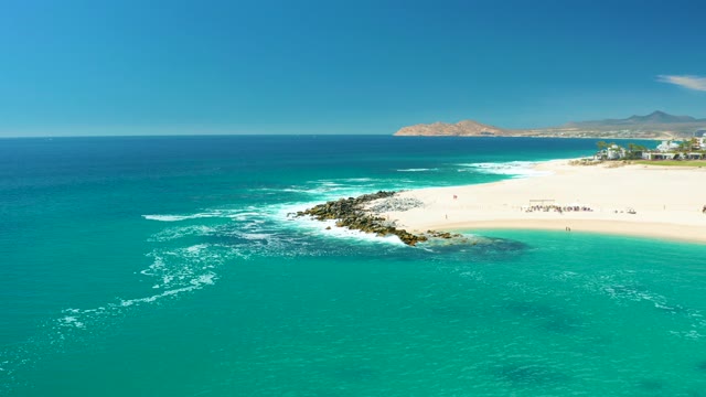 MARQUIS LOS CABOS MEXICO-2021: Beachgoers Moving Along a Turquoise Shore