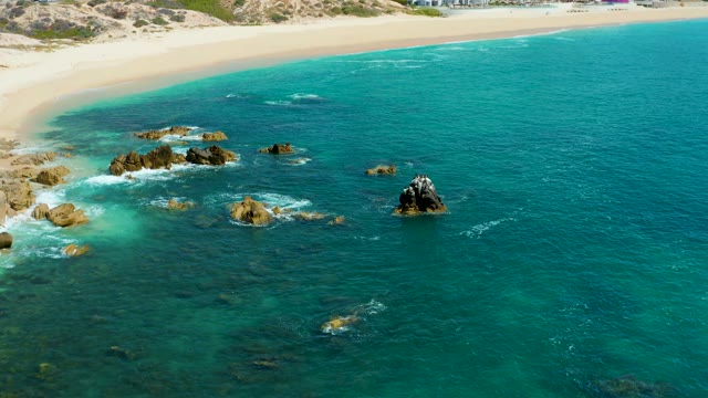 MARQUIS LOS CABOS MEXICO-2021: Rocks in Turquoise Ocean near Sandy Beach