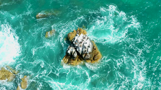MARQUIS LOS CABOS MEXICO-2021: Waves Crashing Against Rocky Ocean Outcrops From Above