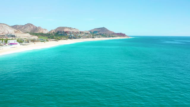 MARQUIS LOS CABOS MEXICO-2021: Beach Coastline with Clear Turquoise Ocean and Mountain Backdrop