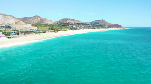 MARQUIS LOS CABOS MEXICO-2021: Sandy Coastline with Turquoise Waters and Mountain Backdrop