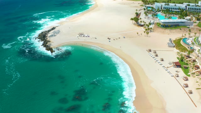 MARQUIS LOS CABOS MEXICO-2021: Waves Crashing on Rocky Beach Shoreline