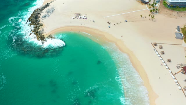 MARQUIS LOS CABOS MEXICO-2021: Sandy Cove with Turquoise Water and Beachgoers Departing