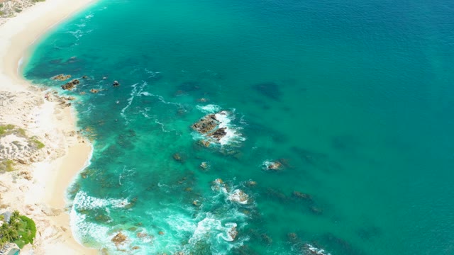 MARQUIS LOS CABOS MEXICO-2021: Waves Crashing on Rocky Shoreline with Turquoise Water