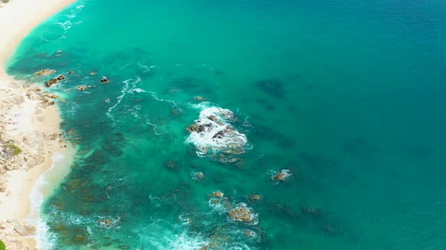 MARQUIS LOS CABOS MEXICO-2021: Coastal Rocks and Crashing Waves in Clear Ocean