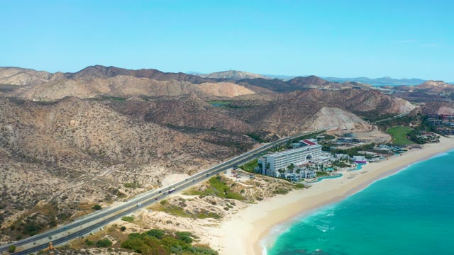 MARQUIS LOS CABOS MEXICO-2021: Vehicles Traveling Along Coastal Highway Near Sandy Beach