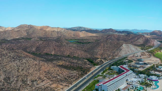 MARQUIS LOS CABOS MEXICO-2021: Desert Highway with Moving Cars and Hotel Building