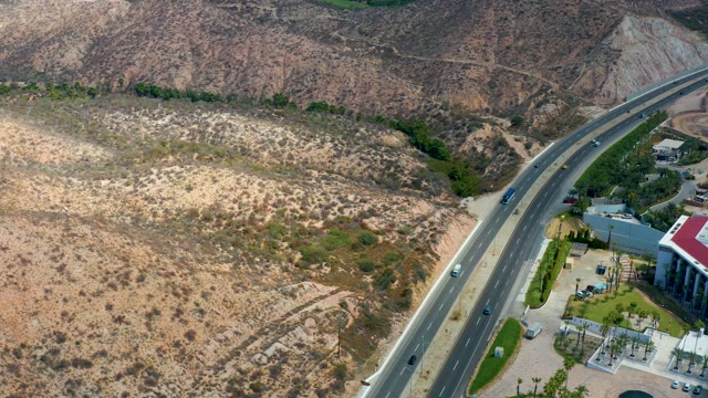 MARQUIS LOS CABOS MEXICO-2021: Vehicles Traveling on Highway Through Arid Hills