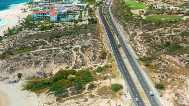 MARQUIS LOS CABOS MEXICO-2021: Coastal Highway Traffic and Sandy Beach