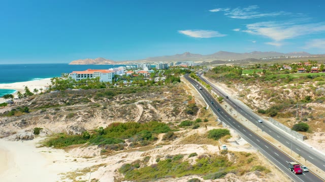 MARQUIS LOS CABOS MEXICO-2021: Coastal Highway Traffic and Beachside Landscape