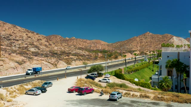 MARQUIS LOS CABOS MEXICO-2021: Highway Traffic Flow with Mountainous Backdrop