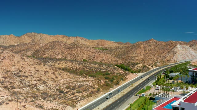 MARQUIS LOS CABOS MEXICO-2021: Highway Traffic Along Desert Mountain Landscape