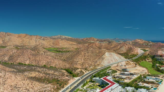 MARQUIS LOS CABOS MEXICO-2021: Vehicles Moving Along Highway Through Arid Hills