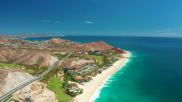 MARQUIS LOS CABOS MEXICO-2021: Coastal Highway with Vehicle Passing by Sandy Beach