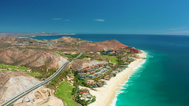 MARQUIS LOS CABOS MEXICO-2021: Coastal Highway Traffic Along Sandy Beach