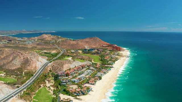 MARQUIS LOS CABOS MEXICO-2021: Vehicles Traveling on Coastal Highway Near Sandy Beach