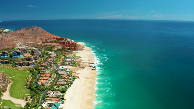 MARQUIS LOS CABOS MEXICO-2021: Waves Breaking on Sandy Shore with Moving Clouds
