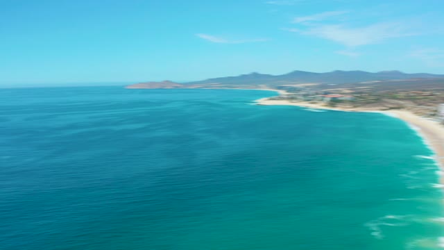 MARQUIS LOS CABOS MEXICO-2021: Sandy Beach with Turquoise Ocean Waves and Beachgoers