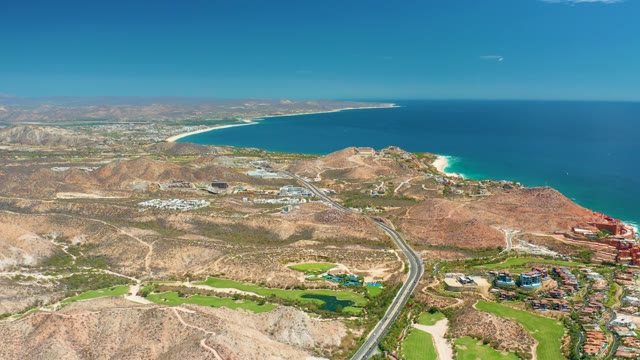 MARQUIS LOS CABOS MEXICO-2021: Coastal Hills, Ocean, and Road with Moving Vehicle