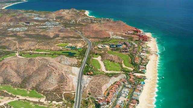 MARQUIS LOS CABOS MEXICO-2021: Vehicle Traveling Along Coastal Road near Hills and Beach