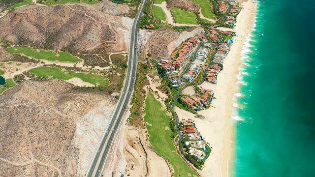 MARQUIS LOS CABOS MEXICO-2021: Coastal Highway with Moving Vehicles and Oceanfront Buildings