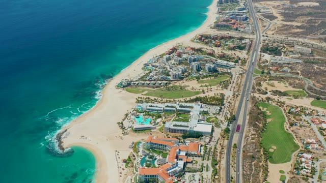 MARQUIS LOS CABOS MEXICO-2021: Coastal Highway with Vehicle Traveling Past Sandy Beach
