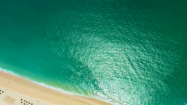 MARQUIS LOS CABOS MEXICO-2021: Ocean Waves Gently Rolling Onto Sandy Shore