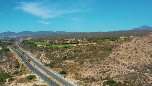 MARQUIS LOS CABOS MEXICO-2021: Highway Traffic Through Arid Hills
