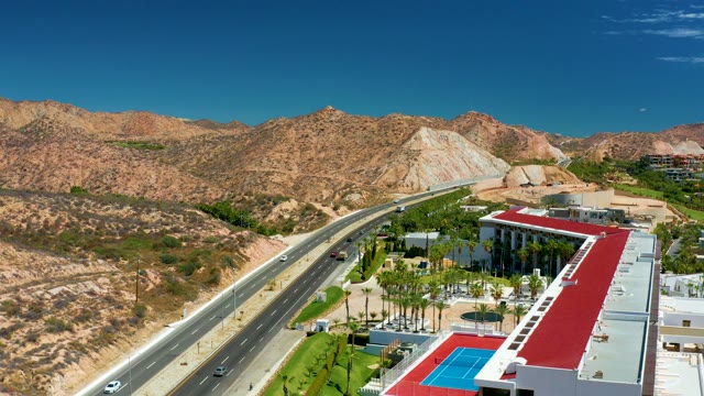MARQUIS LOS CABOS MEXICO-2021: Highway Traffic with Desert Mountains and Building