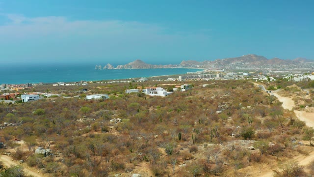 CABO SAN LUCAS BCS MEXICO-2021: Dry Coastal Terrain with Distant Ocean and Road
