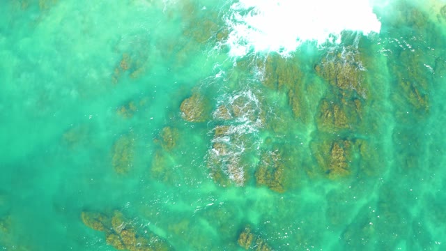 DREAMS LOS CABOS BCS MEXICO-2021: Clear Turquoise Water Over Rocky Seabed with Receding Wave