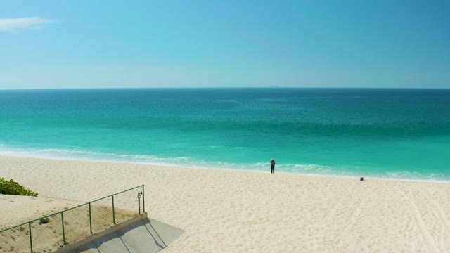 DREAMS LOS CABOS BCS MEXICO-2021: Beachgoer Walking Along Sandy Ocean Shore