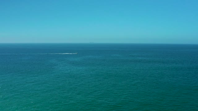 DREAMS LOS CABOS BCS MEXICO-2021: Boat Creating Wake on Turquoise Ocean