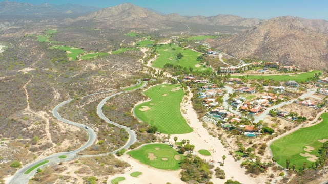 DREAMS LOS CABOS BCS MEXICO-2021: Golf Course with Winding Road and Passing Car