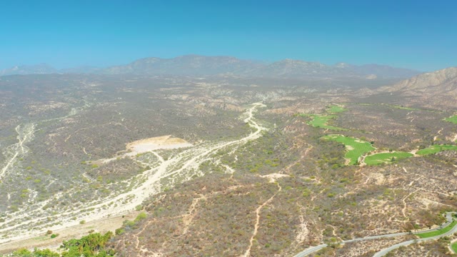 DREAMS LOS CABOS BCS MEXICO-2021: Winding Road Through Hilly Terrain with Green Patches
