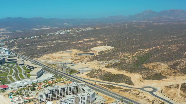 DREAMS LOS CABOS BCS MEXICO-2021: Desert Highway with Buildings and Distant Mountains
