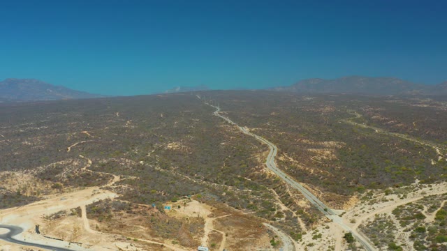 DREAMS LOS CABOS BCS MEXICO-2021: Vehicles Traveling on Winding Roads Through Hilly Terrain