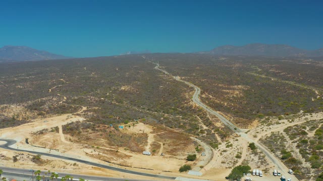 DREAMS LOS CABOS BCS MEXICO-2021: Arid Hills, Highway, and Parking Lot with Palm Trees