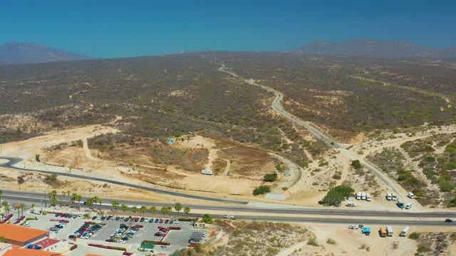 DREAMS LOS CABOS BCS MEXICO-2021: Building with Red Roof Near Highway and Parking Lot