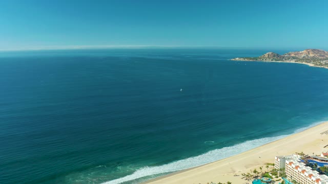 SAN JOSE DEL CABO BCS MEXICO-2021: Gentle Ocean Waves Rolling Onto Sandy Shore
