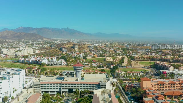 SAN JOSE DEL CABO BCS MEXICO-2021: Urban Landscape with Water Tower and Mountain Backdrop
