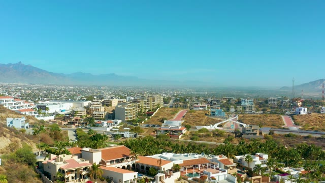 SAN JOSE DEL CABO BCS MEXICO-2021: Cityscape with Red-Tiled Roofs and Distant Mountains